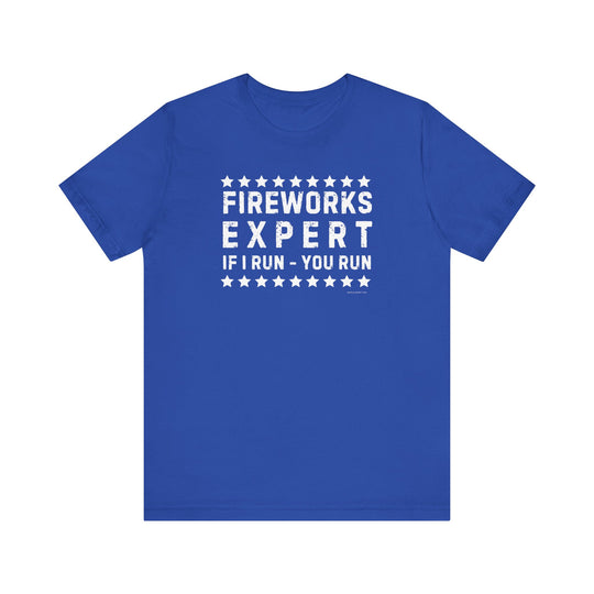 Firework Expert Tee: Unisex jersey shirt with white text on blue fabric. 100% Airlume combed cotton, ribbed knit collars, tear away label. Retail fit, true to size. Ideal for casual wear.
