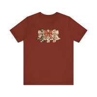 Camo Christmas Tree Tee: Rust T-shirt featuring three camo-patterned, bell-shaped graphics with bows, showcasing a unique holiday design. Soft cotton, unisex fit, sizes S to 3XL.