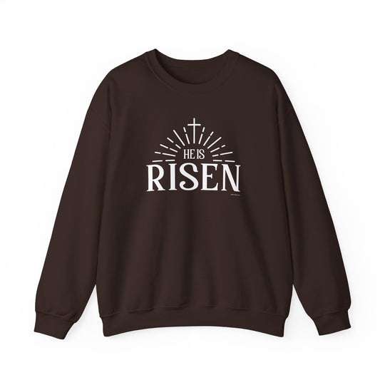 A unisex heavy blend crewneck sweatshirt, He is Risen Crew, in brown with white text. Made of 50% cotton and 50% polyester, featuring ribbed knit collar and double-needle stitching for durability.