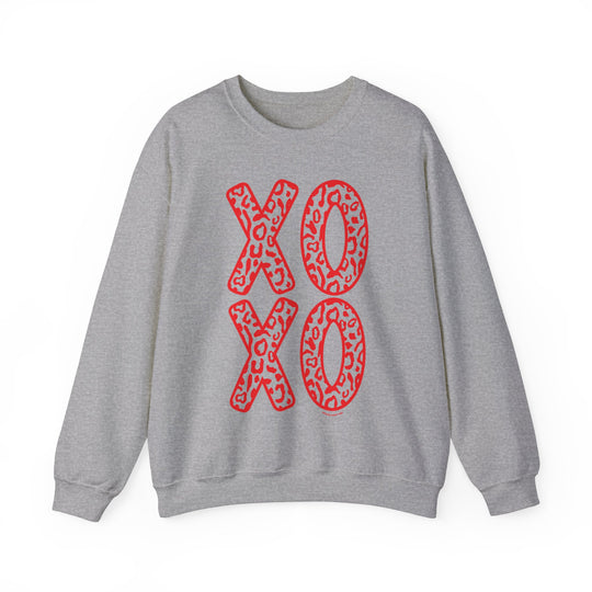 Unisex XOXO Crew sweatshirt with red leopard print and bold red letters on grey fabric. Comfortable blend of polyester and cotton, ribbed knit collar, loose fit, and no itchy side seams. Ideal for all occasions.