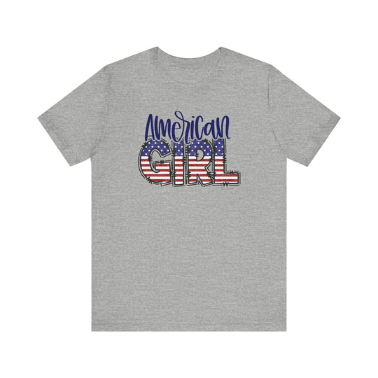 American Girl Tee: A grey t-shirt featuring a flag design and red, white, and blue text. Unisex jersey tee with ribbed knit collars, taping on shoulders, and 100% Airlume combed cotton.