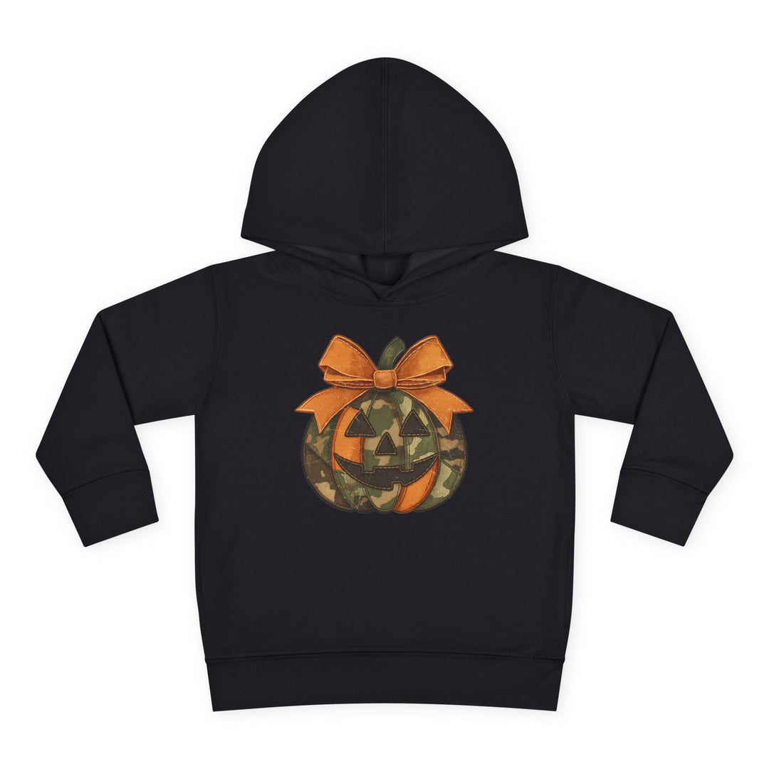 Jackie O Toddler Hoodie featuring a camouflage and orange jack-o’-lantern graphic with an orange bow on the stem, designed for comfort and durability.
