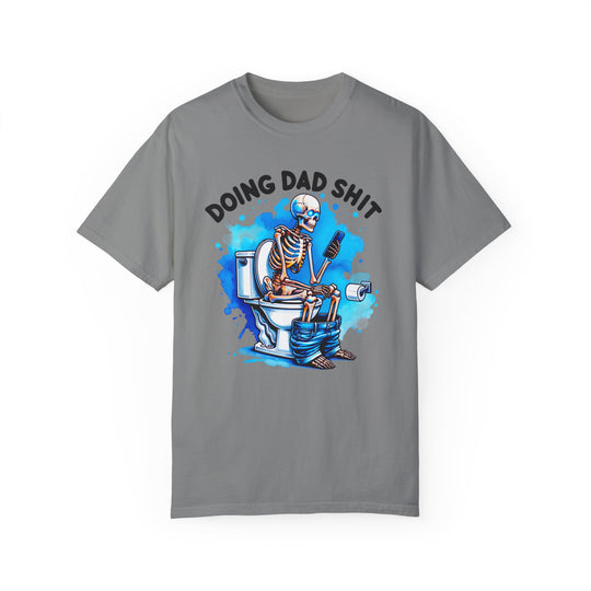 A grey t-shirt featuring a skeleton on the toilet, part of the Doing Dad Shit Tee collection at Worlds Worst Tees. Made of 100% ring-spun cotton, with a relaxed fit and durable double-needle stitching.