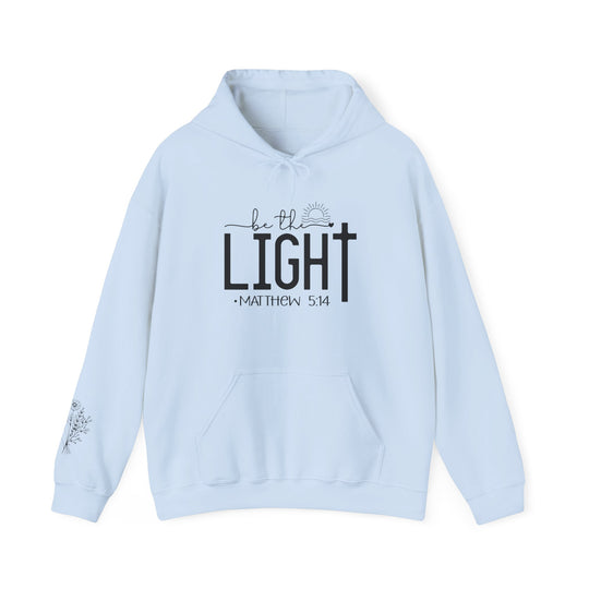 A cozy unisex Be the Light Hoodie in light blue with black text. Made of 50% cotton, 50% polyester blend for warmth and comfort. Features a kangaroo pocket and matching drawstring hood.