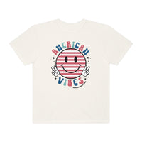 A relaxed fit American Vibes Tee, featuring a smiley face design on white cotton. Garment-dyed for coziness, with durable double-needle stitching and a seamless finish. Made for everyday comfort.