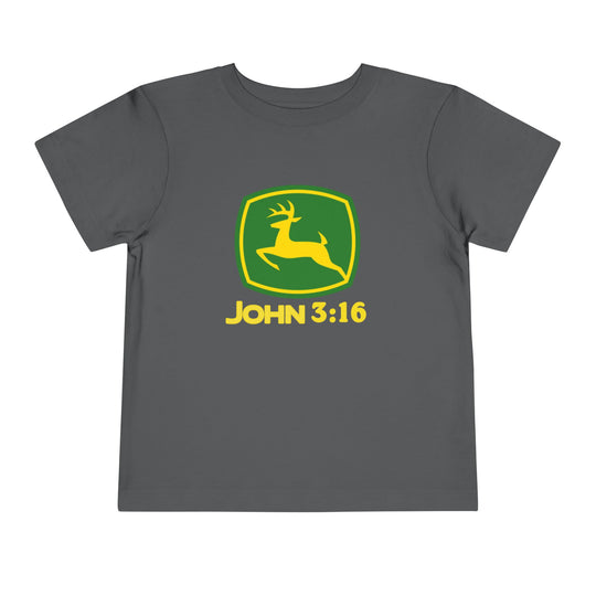 John 3:16 Toddler Tee showcasing a parody John Deere logo with a yellow deer inside a green shield, printed on a dark-gray Bella Canvas t-shirt.