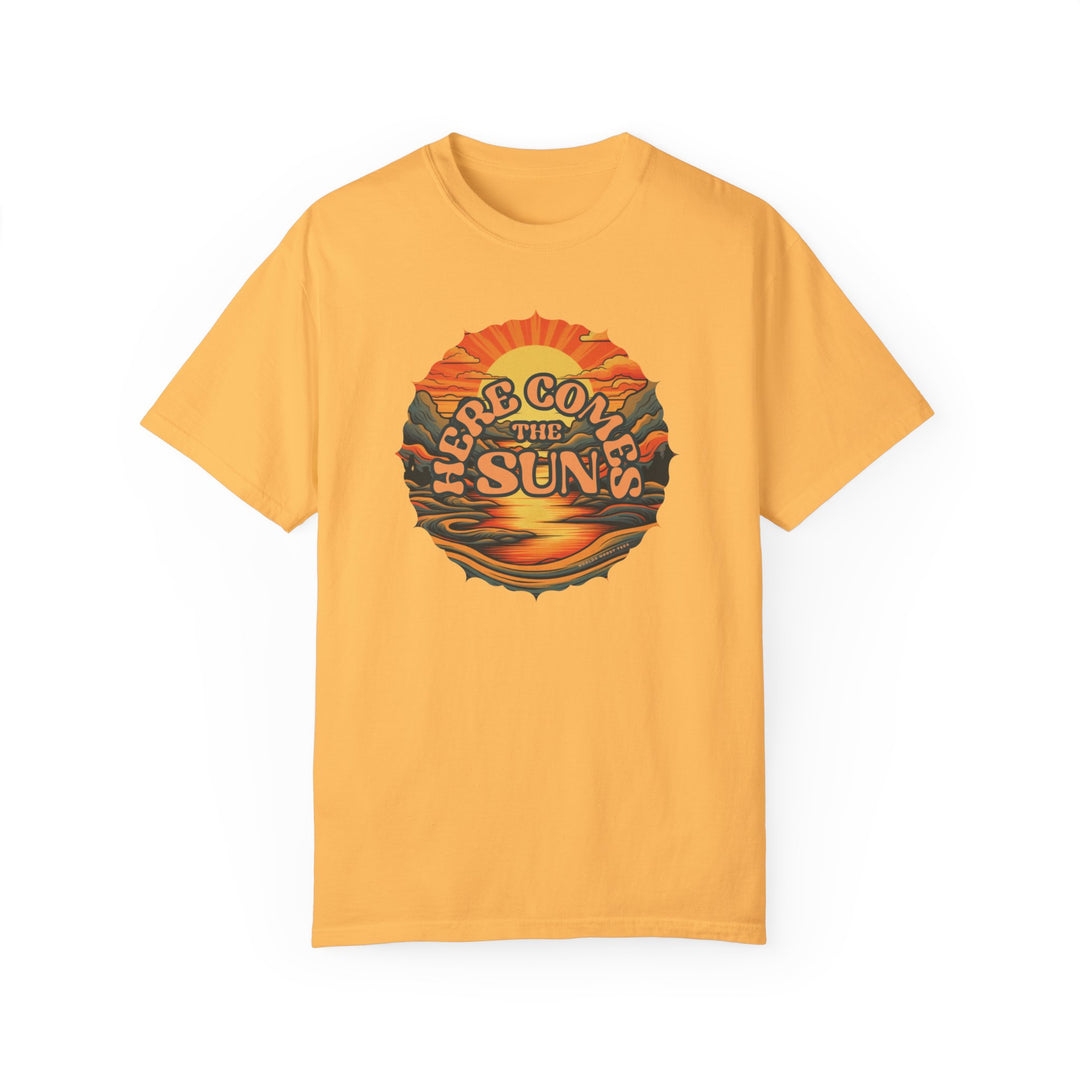 A relaxed fit Here Comes The Sun Tee, a yellow shirt with a graphic sunset and mountain design. 100% ring-spun cotton, medium weight, durable double-needle stitching, and seamless sides for comfort.