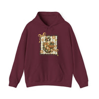 Burgundy hoodie featuring a whimsical ghost in a patchwork blanket with a pumpkin, framed by vines and flowers. Cozy, unisex design with kangaroo pocket.