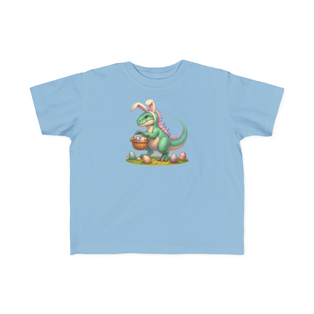 Eggosaurus Toddler Tee: A blue t-shirt featuring a cartoon dinosaur holding a basket of eggs, perfect for sensitive toddler skin. Made of 100% combed ringspun cotton, light fabric, classic fit, and tear-away label.