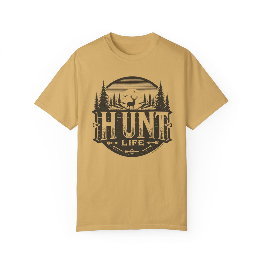 A Hunt Life Tee, featuring a tan t-shirt with a deer and trees graphic design. Made of 100% ring-spun cotton for coziness, with double-needle stitching for durability and a relaxed fit for daily wear.