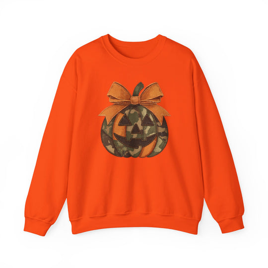 Jackie O Crew: Bright orange crewneck sweatshirt featuring a stylized jack-o’-lantern with camouflage and solid panels, topped with a large bow.