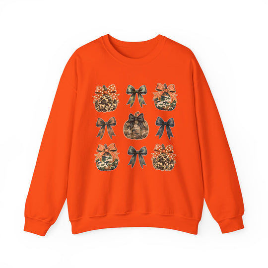 Bright-orange crewneck sweatshirt featuring a 3x3 grid of camo and animal-print pumpkins and bows, perfect for Halloween or harvest season. Comfortable, durable, and ideal for colder months.