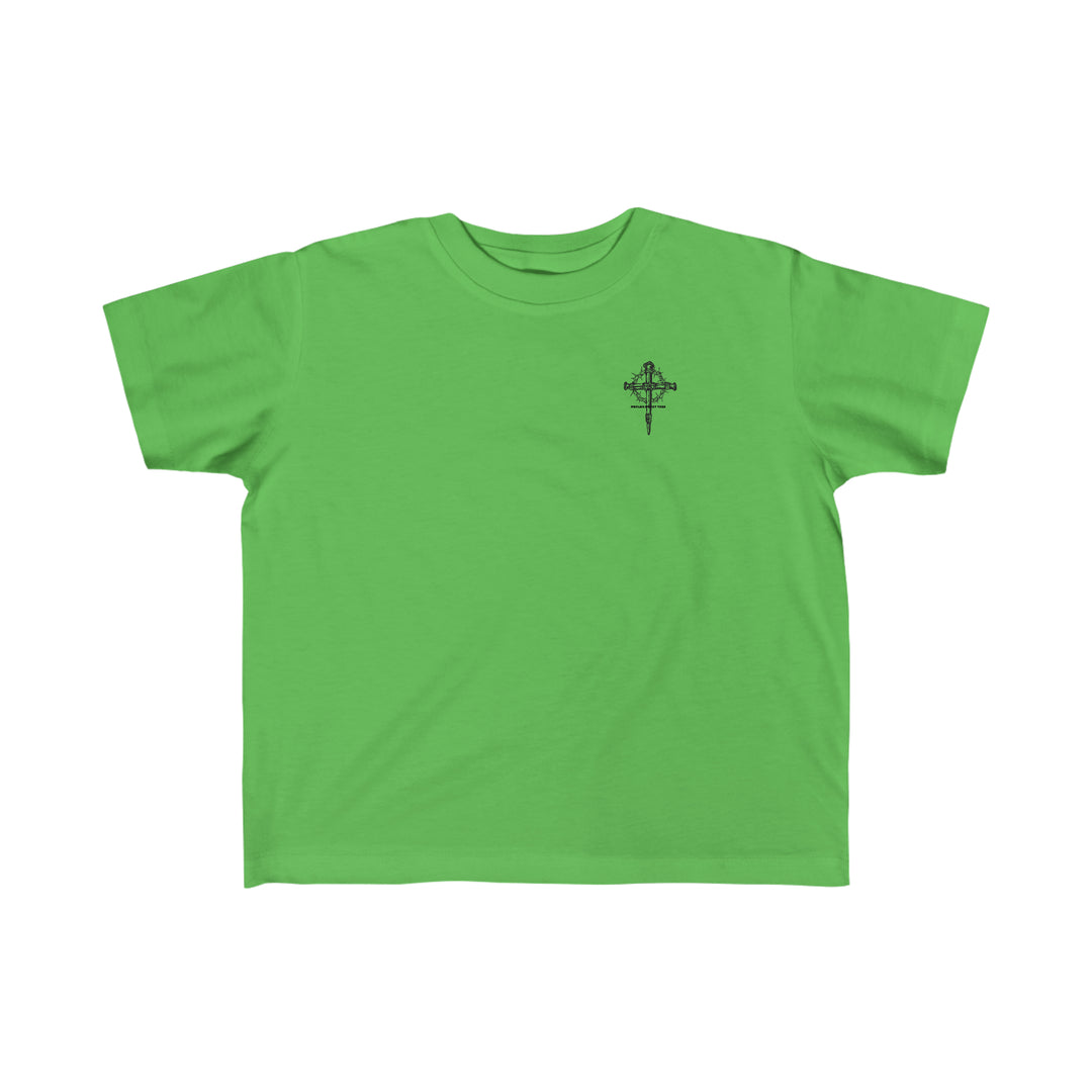 Child of God Tee: A green shirt featuring a black cross logo, perfect for toddlers. Made of 100% combed ringspun cotton, light fabric, classic fit, tear-away label, and true to size.