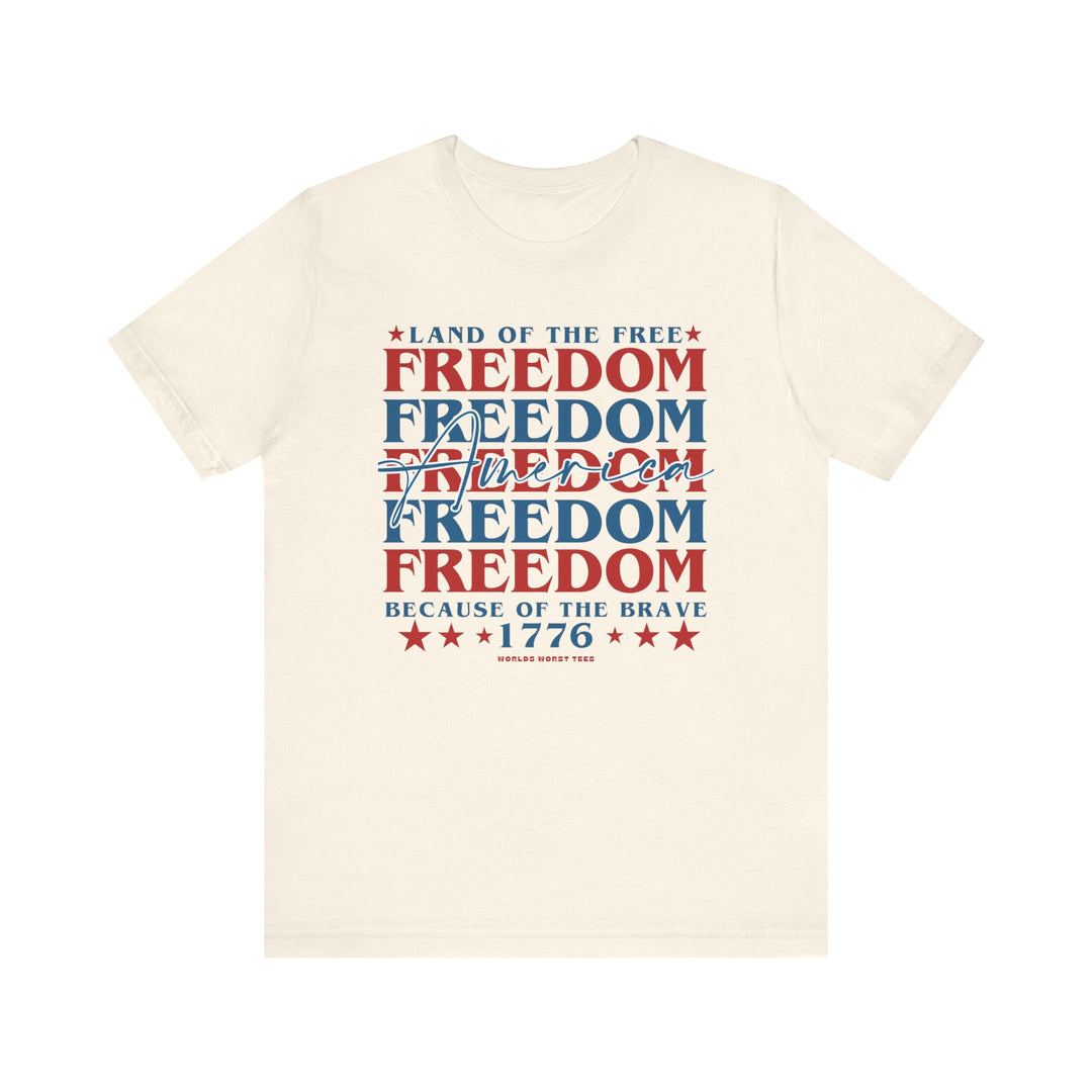 Unisex American Freedom Tee: White shirt with red and blue text. Airlume combed cotton, retail fit, ribbed knit collars, and dual side seams for durability. Sizes XS to 3XL.