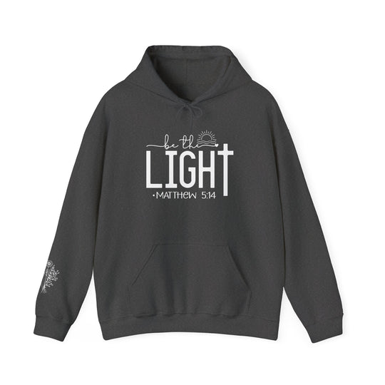 Unisex Be the Light Hoodie: Grey sweatshirt with white text. Thick cotton-polyester blend for warmth. Kangaroo pocket and matching drawstring. Classic fit, tear-away label, true to size.