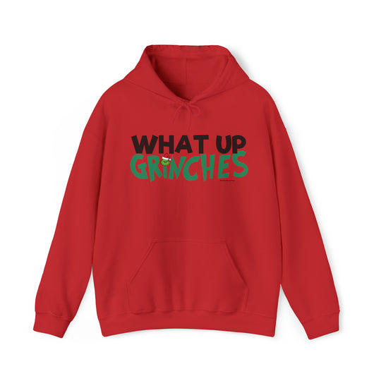 Unisex What up Grinches Hoodie: Red sweatshirt with green and black text. Cotton-polyester blend, kangaroo pocket, drawstring hood. Classic fit, tear-away label, medium-heavy fabric. Ideal for warmth and comfort.