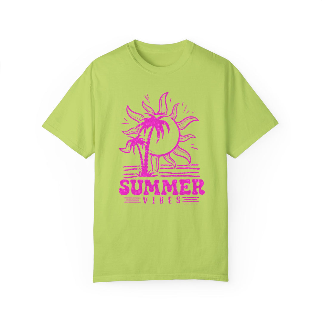 A relaxed fit Summer Vibes Tee, featuring a green shirt with a pink sun and palm trees design. Made of 100% ring-spun cotton for coziness and durability, perfect for daily wear.