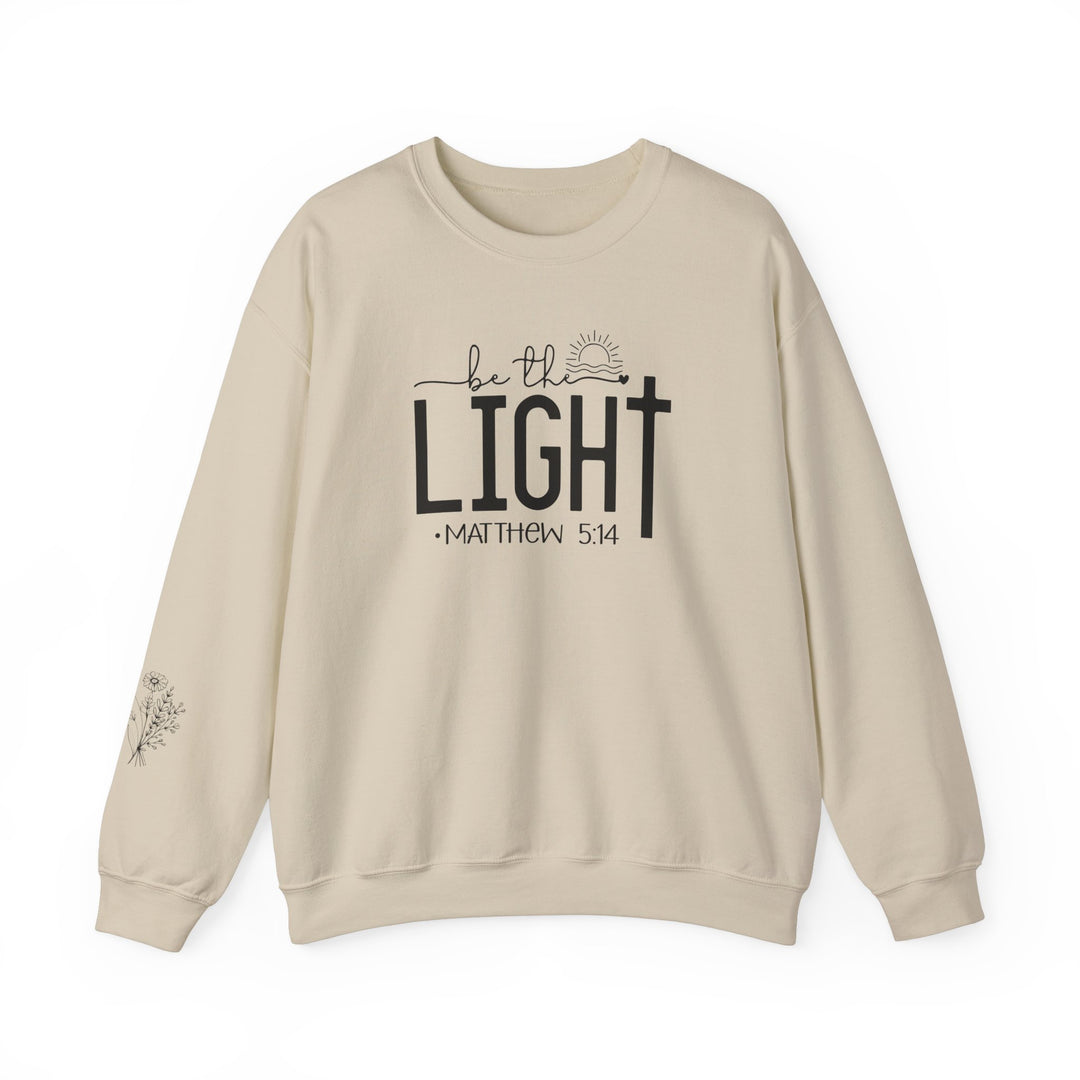 Unisex heavy blend crewneck sweatshirt, Be the Light Crew, in white with black text. Made of 50% cotton and 50% polyester, featuring ribbed knit collar and double-needle stitching for durability. Ethically grown US cotton.