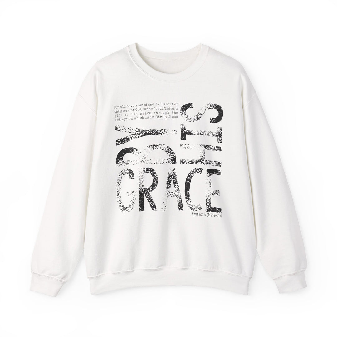 By His Grace Hoodie features a white sweatshirt with BY GRACE in distressed print and Romans 3:23-24 text, offering comfort and durability.