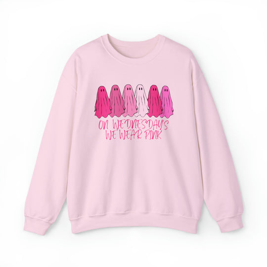 A pink crewneck sweatshirt featuring pink and white ghost designs. Unisex heavy blend fabric for comfort, ribbed knit collar, and no itchy side seams. Ideal for any occasion. From Worlds Worst Tees.