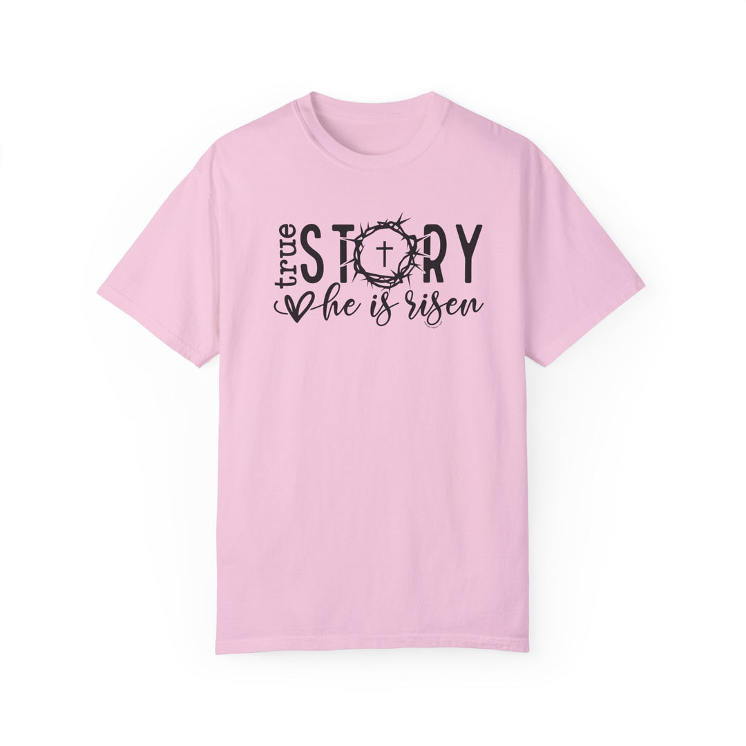 Relaxed fit True Story He is Risen Tee, pink shirt with black text. 100% ring-spun cotton, garment-dyed for coziness. Durable double-needle stitching, no side-seams for tubular shape.