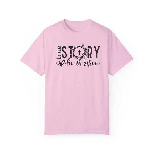 Relaxed fit True Story He is Risen Tee, pink shirt with black text. 100% ring-spun cotton, garment-dyed for coziness. Durable double-needle stitching, no side-seams for tubular shape.