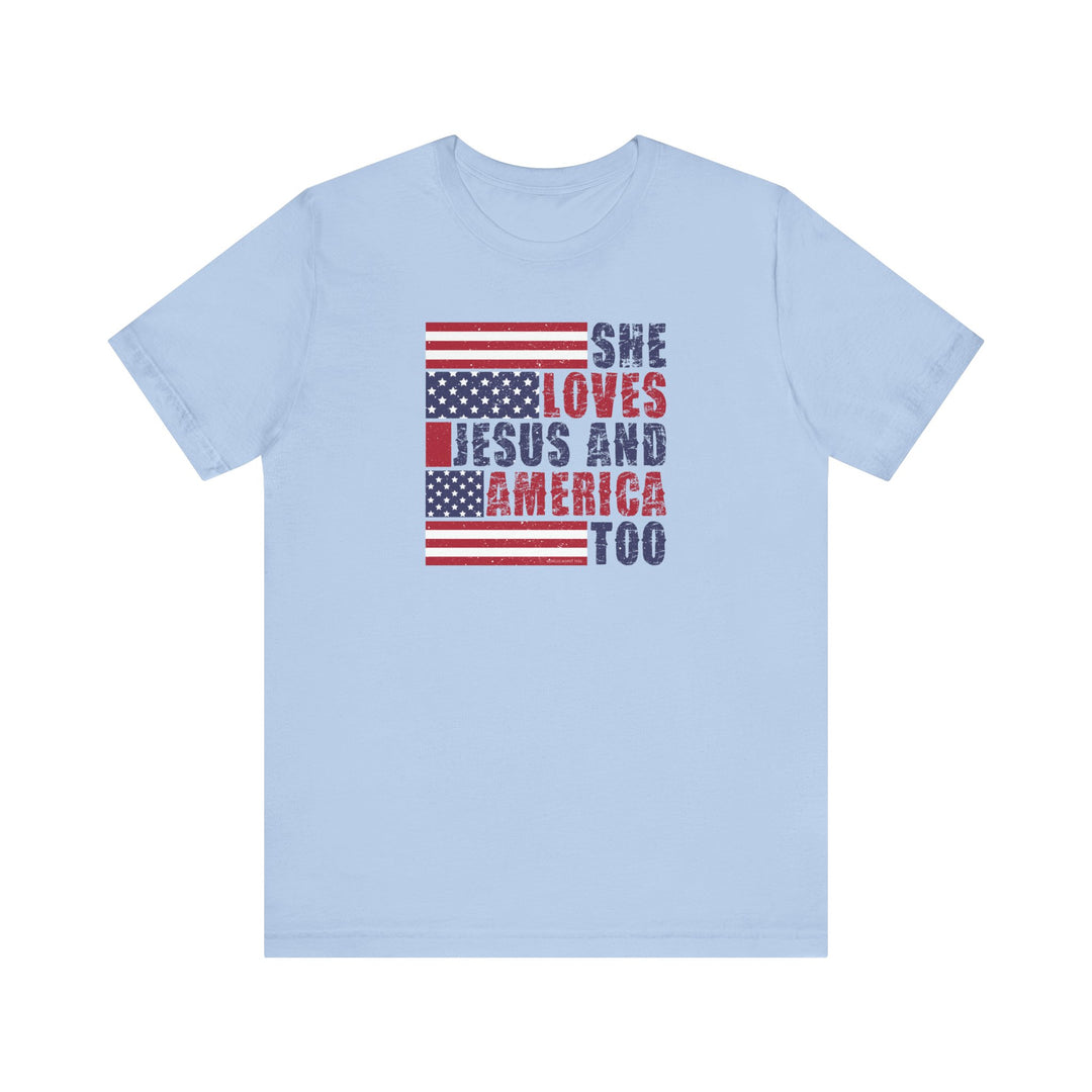 A unisex She Loves Jesus and America Tee, featuring red and blue text on a blue shirt. Made of 100% cotton, with ribbed knit collars for a comfortable fit. Retail fit, tear away label, true to size.