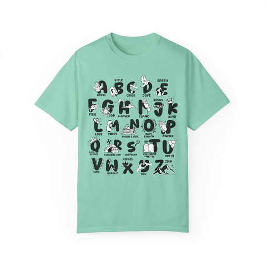 A green Bible Alphabet Tee, featuring black letters and symbols. 100% ring-spun cotton, garment-dyed for coziness. Relaxed fit, double-needle stitching for durability, seamless design. Ideal for daily wear.