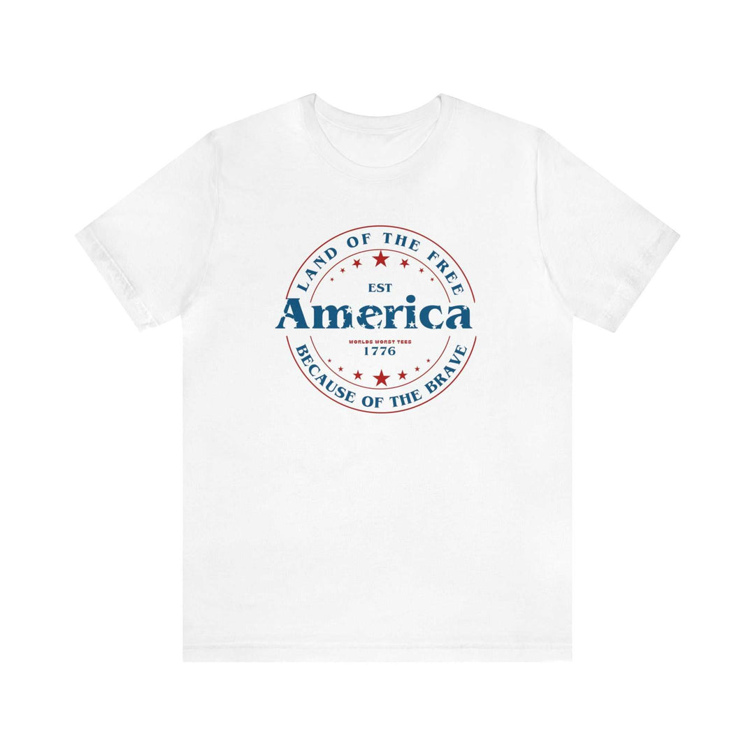 A classic America Land of the Free Tee in white with red and blue text. Unisex jersey tee made of 100% cotton, featuring ribbed knit collars and taping on shoulders for a comfortable fit.