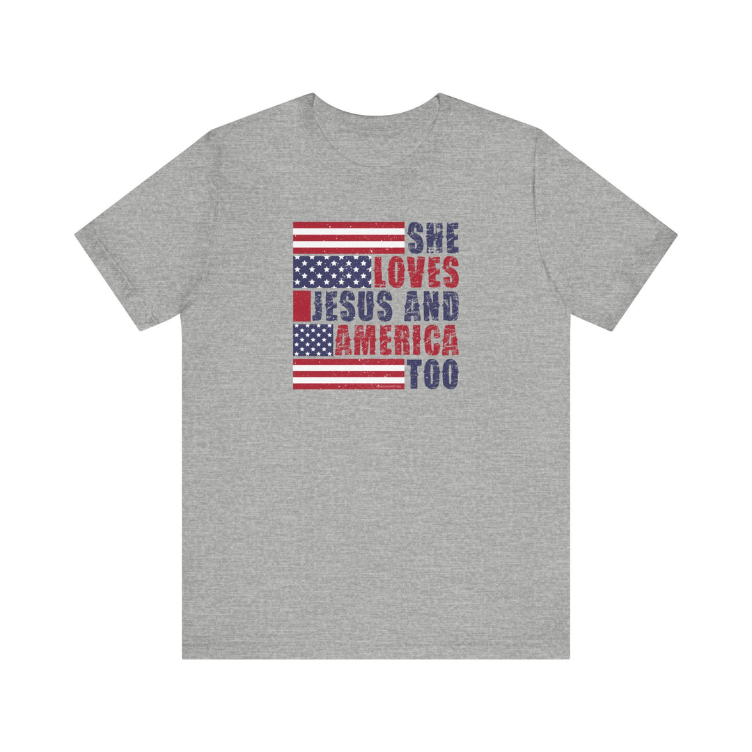 A She Loves Jesus and America Tee, a grey t-shirt with red and blue text. Unisex jersey shirt with ribbed knit collar, 100% cotton, retail fit, tear away label. Sizes XS to 3XL.