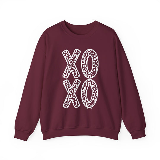 Unisex XOXO Crew sweatshirt, maroon with white leopard print letters. Heavy blend fabric, ribbed knit collar, no itchy side seams. Sizes from S to 5XL. Ideal for comfort and style.