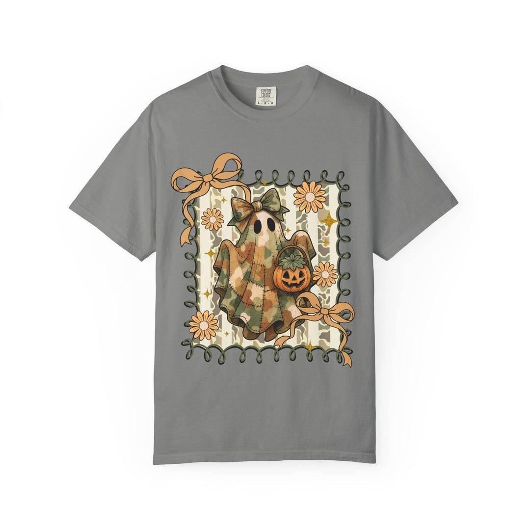 Quilted Ghost Tee: Gray T-shirt featuring a camo-patterned ghost with a bow, holding a Jack-o’-lantern, framed by ribbon and orange flowers.