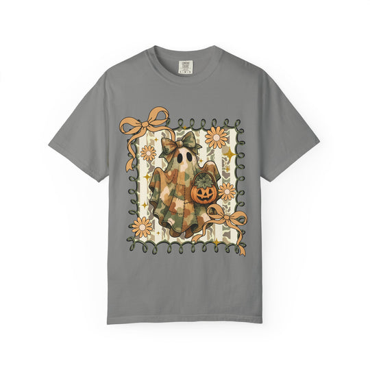 Quilted Ghost Tee: Gray T-shirt featuring a camo-patterned ghost with a bow, holding a Jack-o’-lantern, framed by ribbon and orange flowers.