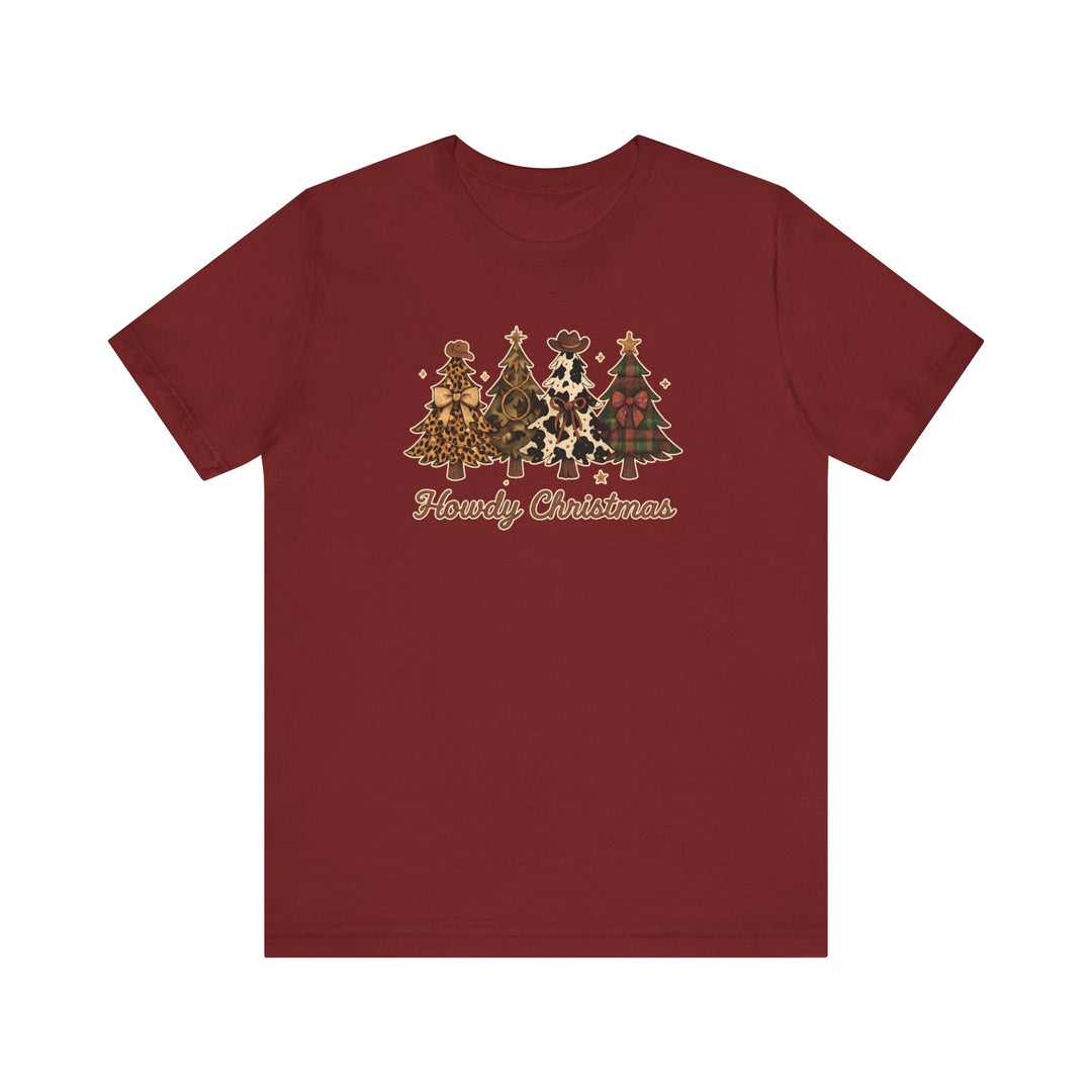 Howdy Christmas Tee with four Western-themed Christmas trees featuring prints like leopard, camouflage, cowhide, and plaid, adorned with cowboy hats and bows.