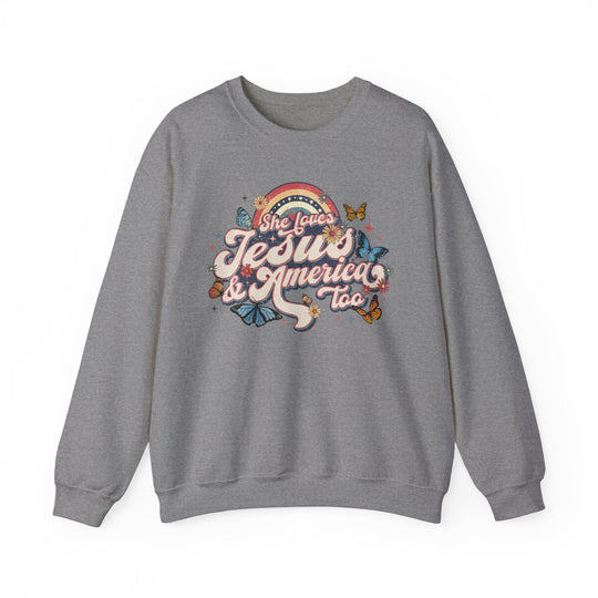 A grey crewneck sweatshirt featuring the She Loves Jesus and America graphic design. Unisex heavy blend with ribbed knit collar, no itchy side seams. Made of 50% cotton and 50% polyester.