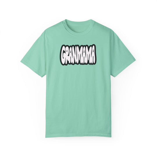 A Grandmama Tee: A green shirt with white text, garment-dyed 100% ring-spun cotton, medium weight, relaxed fit, double-needle stitching, no side-seams. Durable, cozy, and tubular-shaped.