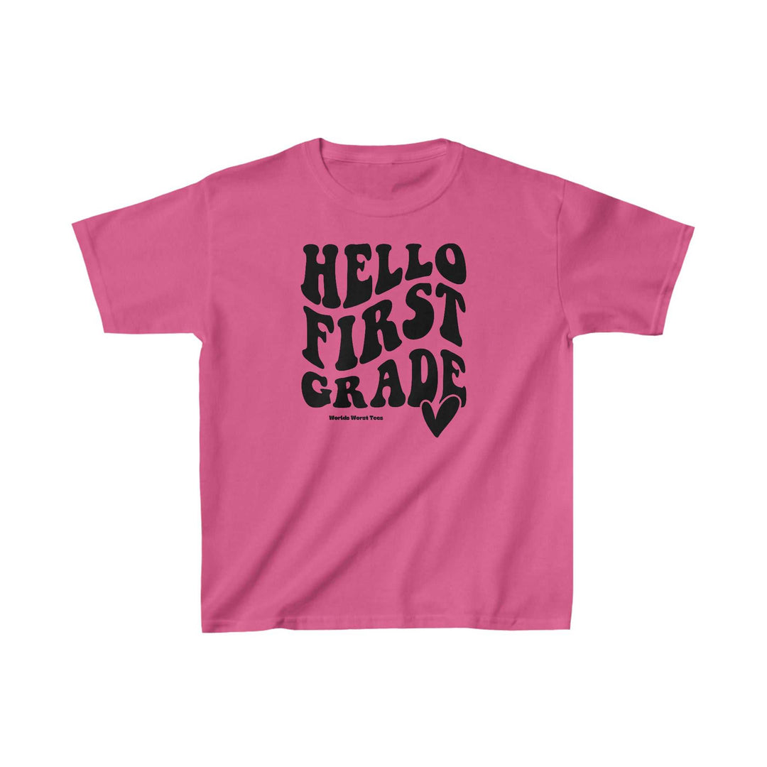 A 1st Grade Tee for kids, a pink shirt with black text. 100% cotton, light fabric, classic fit, tear-away label. Perfect for everyday wear. Sizes: XS to XL.