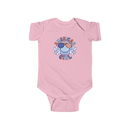 American Girl Onesie, pink bodysuit with cartoon character, peace sign, and flag. Soft 100% cotton fabric, ribbed knitting for durability, plastic snaps for easy changing. Ideal for infants.