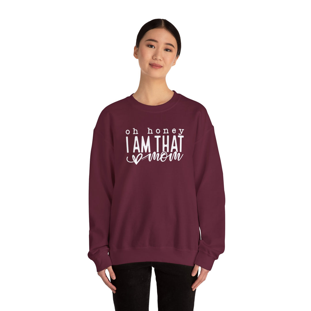 A maroon sweatshirt featuring the Oh Honey I'm that Mom Crew design. Unisex heavy blend, ribbed knit collar, no itchy side seams. 50% cotton, 50% polyester, loose fit, medium-heavy fabric.