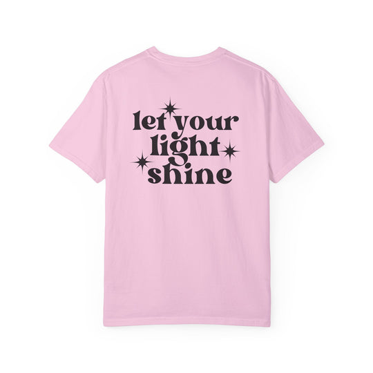 Relaxed fit Let Your Light Shine Tee, pink shirt with black text. 100% ring-spun cotton, garment-dyed for coziness. Double-needle stitching, no side-seams for durability and shape retention.