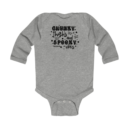 Chunky Thighs and Spooky Vibes Long Sleeved Onesie for infants in grey with black text. 100% cotton, plastic snaps, ribbed bindings for durability. From Worlds Worst Tees.
