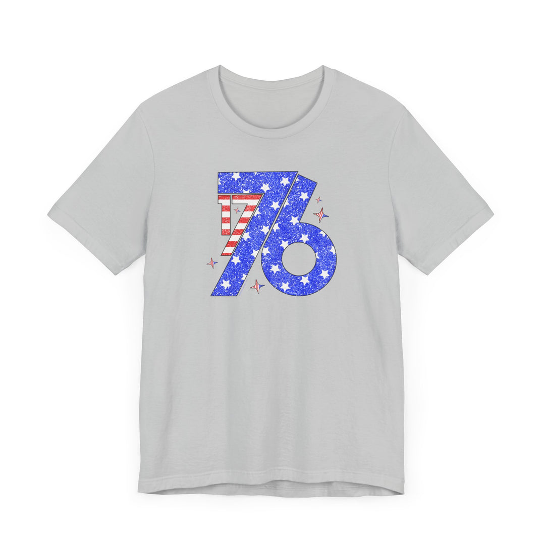 A grey 1776 Tee with stars and stripes design on a soft cotton jersey shirt. Unisex fit with ribbed knit collar, taping on shoulders, and tear away label. A patriotic favorite from Worlds Worst Tees.
