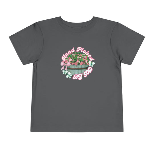 Toddler wearing Hand Picked by GOD t-shirt, showcasing its soft, 100% Airlume cotton fabric, ideal for everyday comfort.