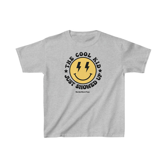 A kids heavy cotton tee, The Cool Kid Just Showed Up, in a classic fit with a yellow and black design. Made of 100% cotton, ideal for printing, featuring twill tape shoulders for durability and a curl-resistant collar.