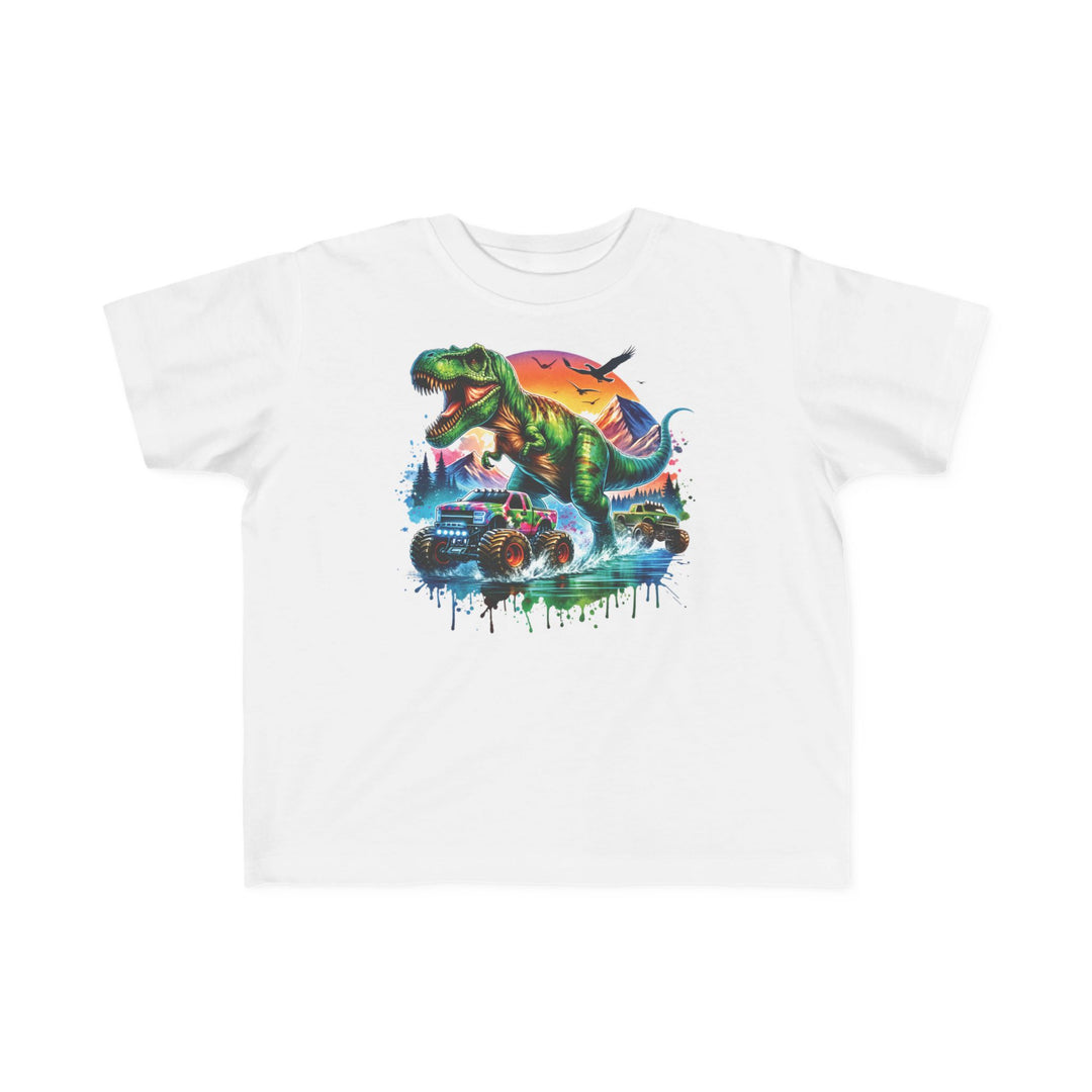 Dino Truck Toddler Tee features a cartoon T-rex and monster trucks against a sunset backdrop, designed for toddler comfort with soft cotton and durable print.