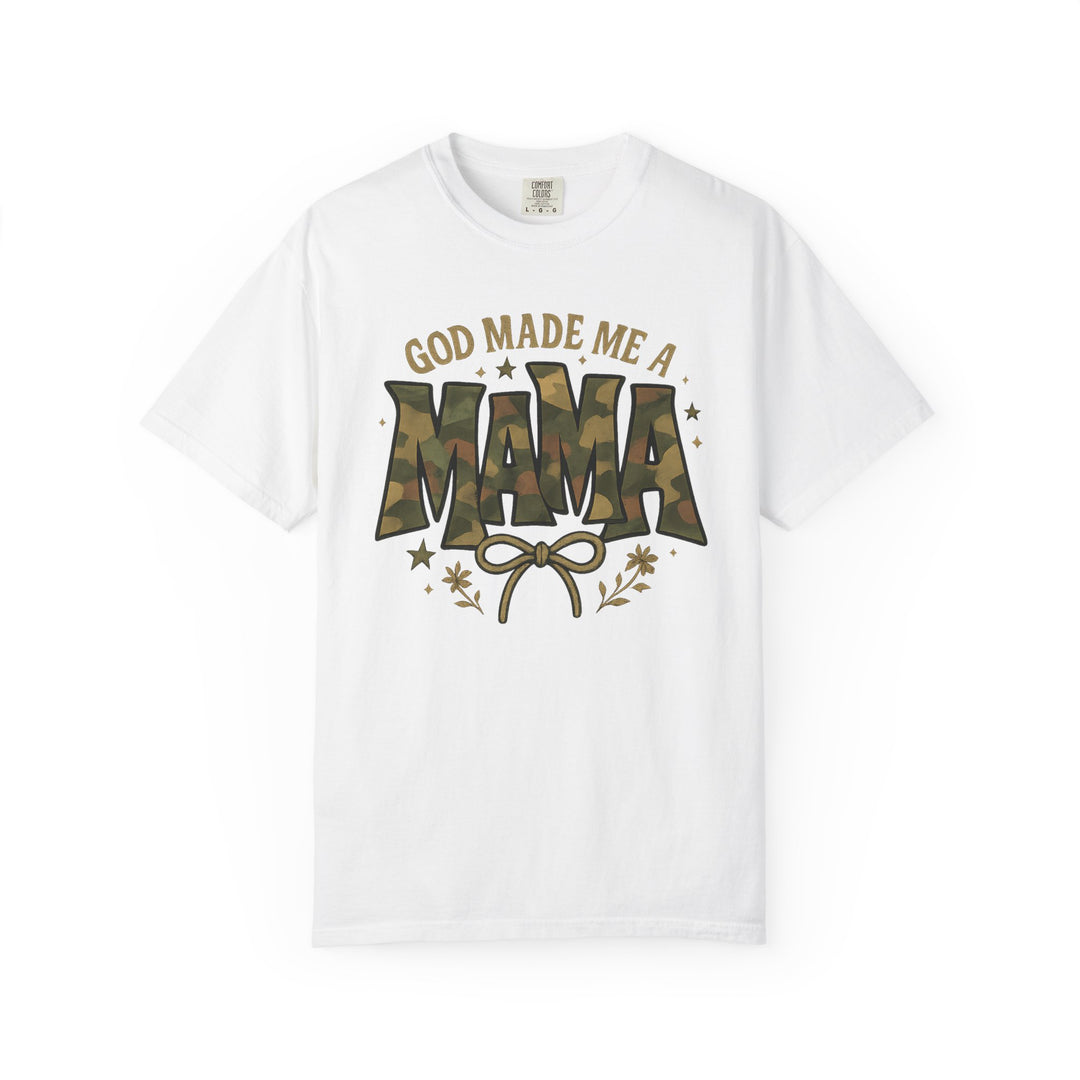 God Made Me a Mama Tee featuring a camouflage-patterned MAMA slogan, floral and star accents, and Comfort Colors tag, showcasing a durable, relaxed-fit design.