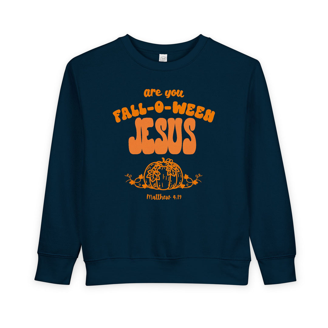 Dark-navy toddler sweatshirt with FALL-O-WEEN JESUS slogan in orange, featuring a pumpkin graphic and Matthew 4:19 reference, offering warmth and playful Christian messaging.