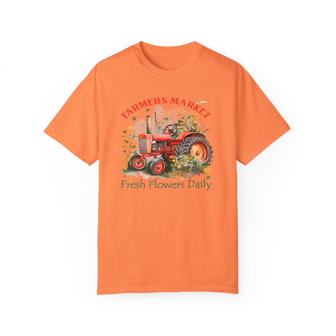Alt text: Fresh Flowers Tee: A relaxed fit t-shirt featuring a tractor design, made of 100% ring-spun cotton for comfort and durability. No side-seams for a seamless look.