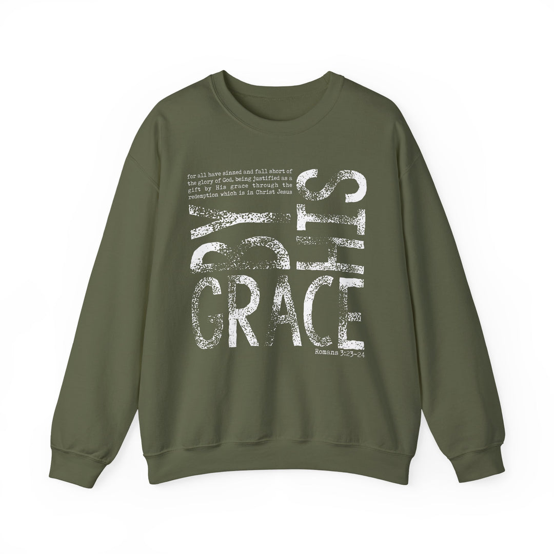 Olive-green unisex sweatshirt with BY GRACE and Romans 3:23–24 in distressed white print, featuring ribbed knit collar and durable double-needle stitching.
