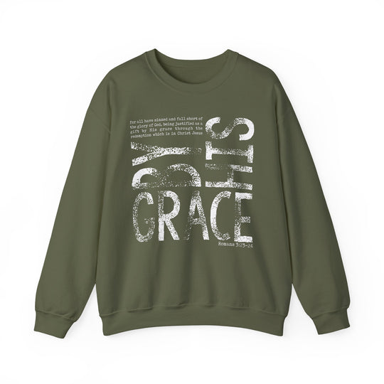Olive-green unisex sweatshirt with BY GRACE and Romans 3:23–24 in distressed white print, featuring ribbed knit collar and durable double-needle stitching.